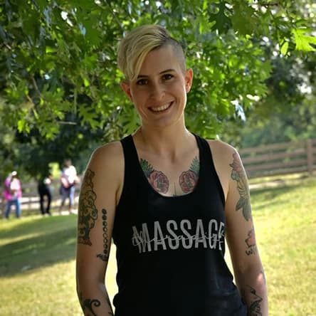 Precision Clinical Bodywork provider with short blonde hair in an outdoor portrait